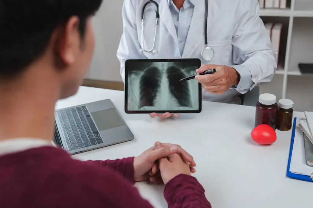 Doctor explaining a chest X-ray to a patient in an office